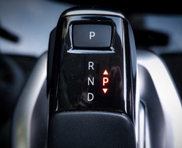 Detailed view of a modern automatic car gear shifter displaying P, R, N, D settings.